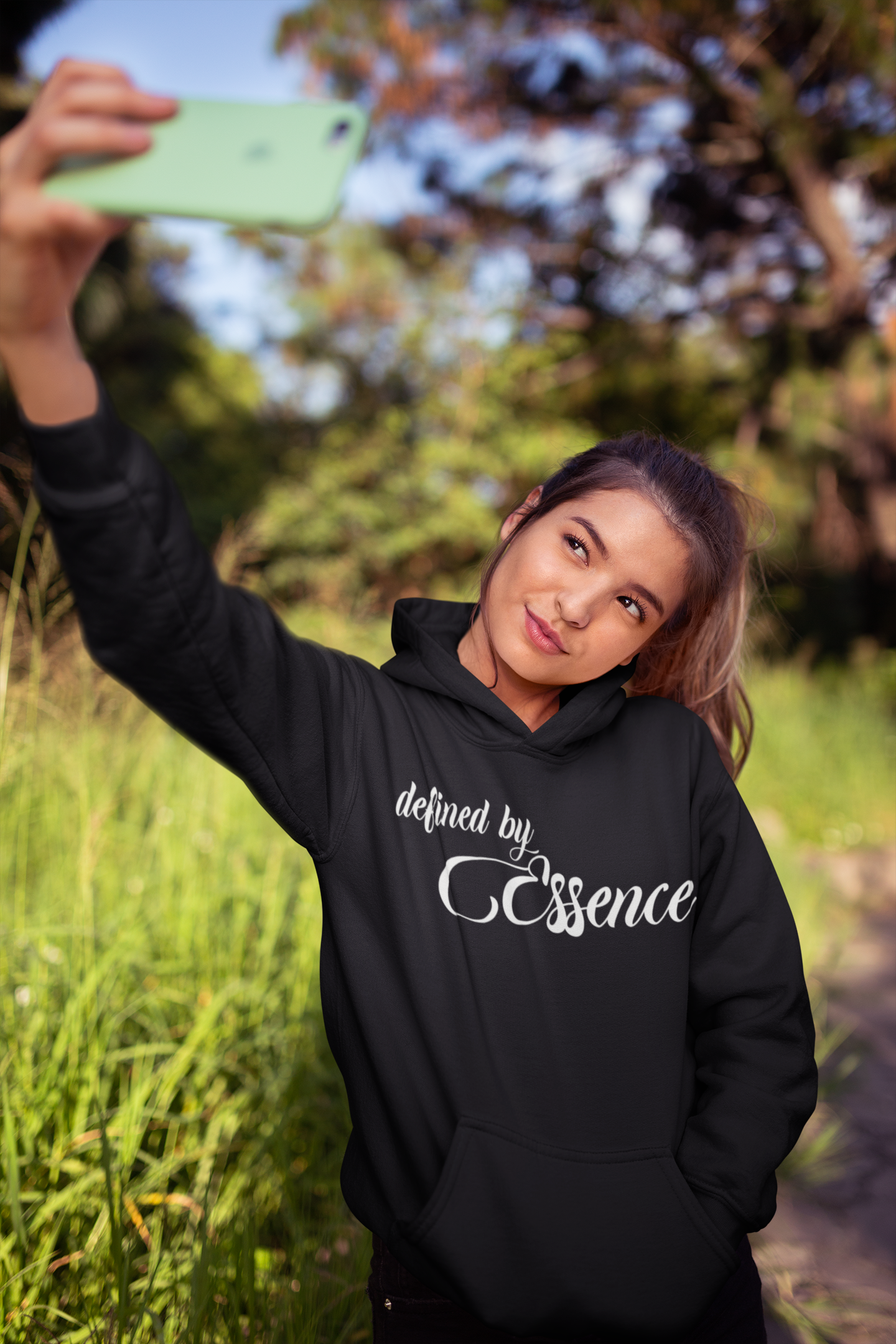 Women wearing a black signature Defined by Essence hoodie during a cool day outside.