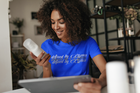 Women wearing royal blue 3d Defined By Essence T- Shirt with multilayering wording reviewing a product.