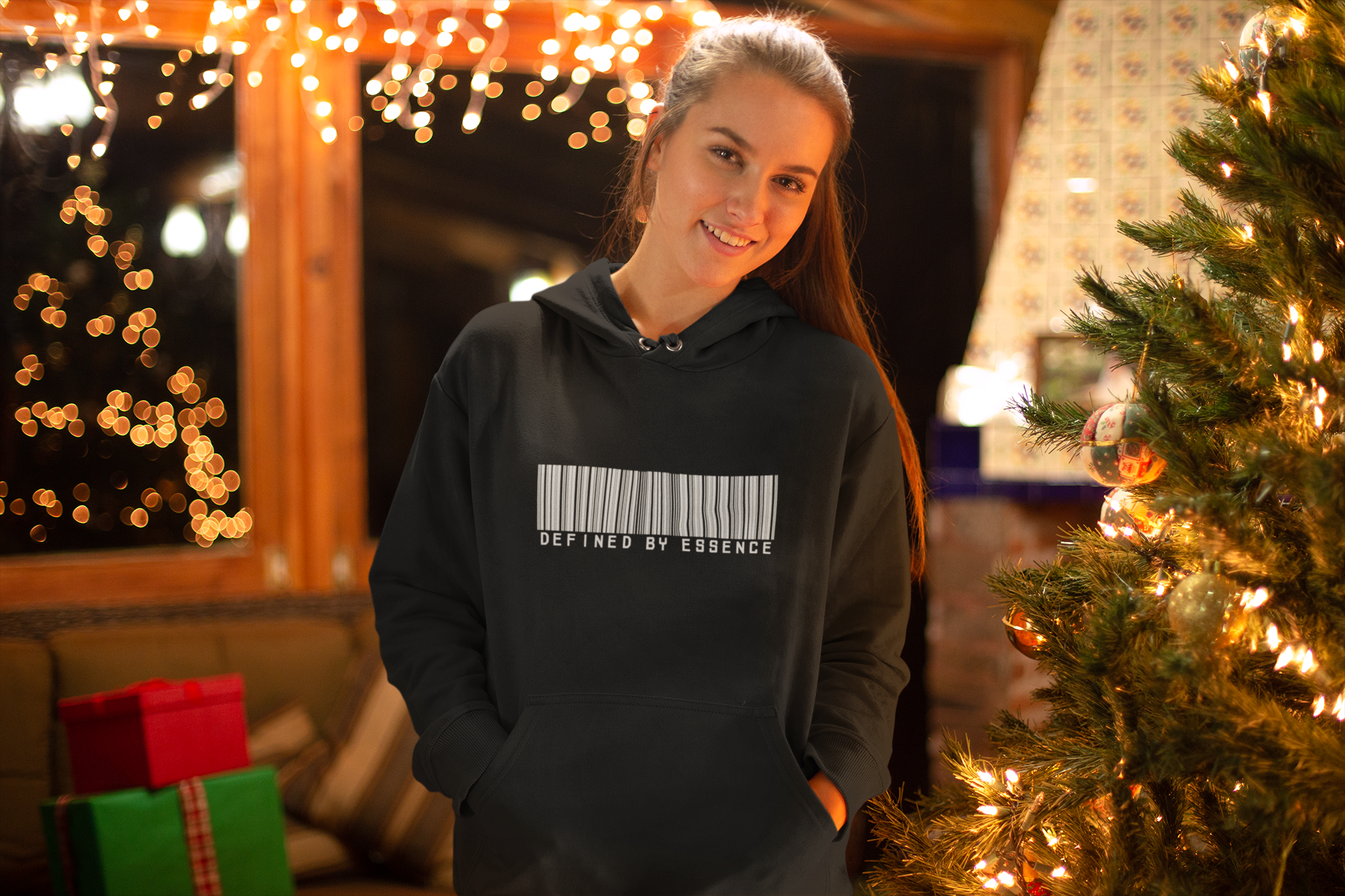Women wearing a black barcoded Defined by Essence hoodie during Christmas.