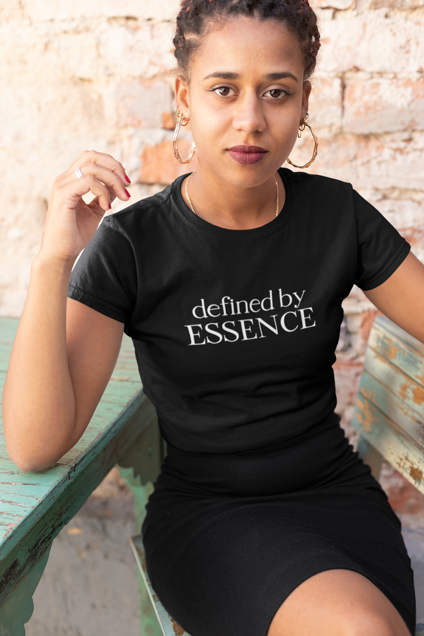 Women wearing Black Defined By Essence T-Shirt sitting on rustic chair