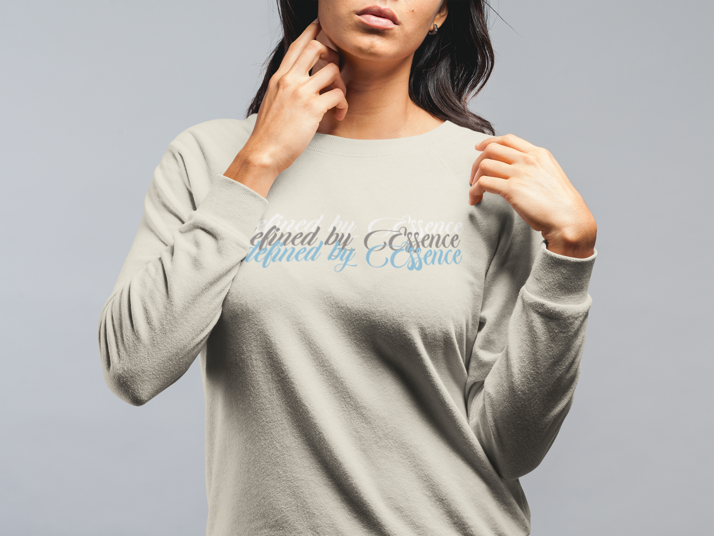 Women wearing a sand Defined By Essence sweatshirt, while modeling.